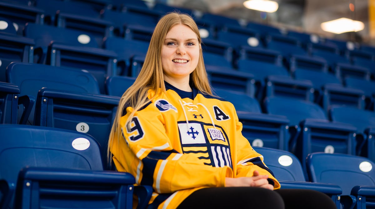 Photo of Raice Szott 鈥�24 sitting in the stands at Lawler Rink.